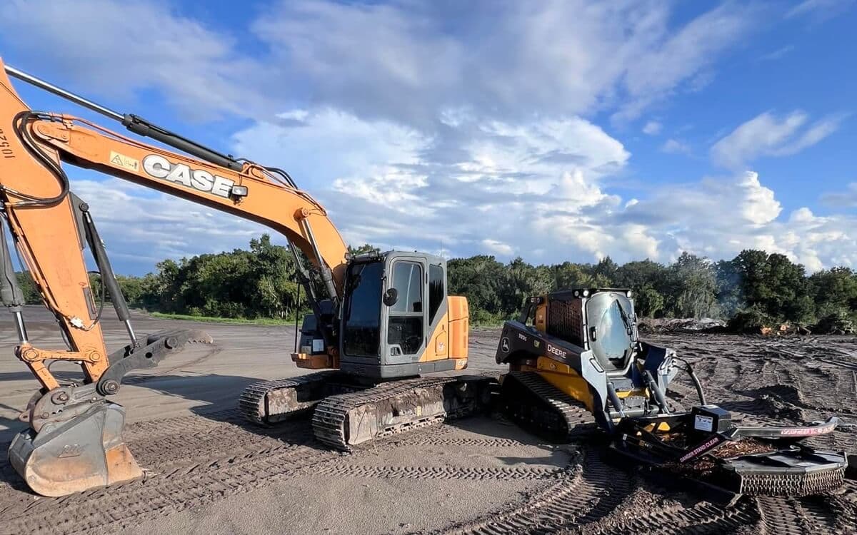 Excavator and skid steer clearing land on a Central Florida job site