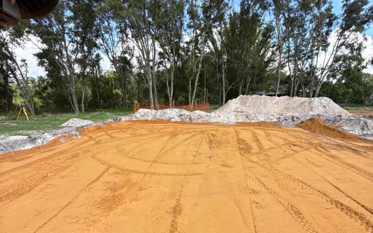 Site preparation with fill dirt being moved on a residential property