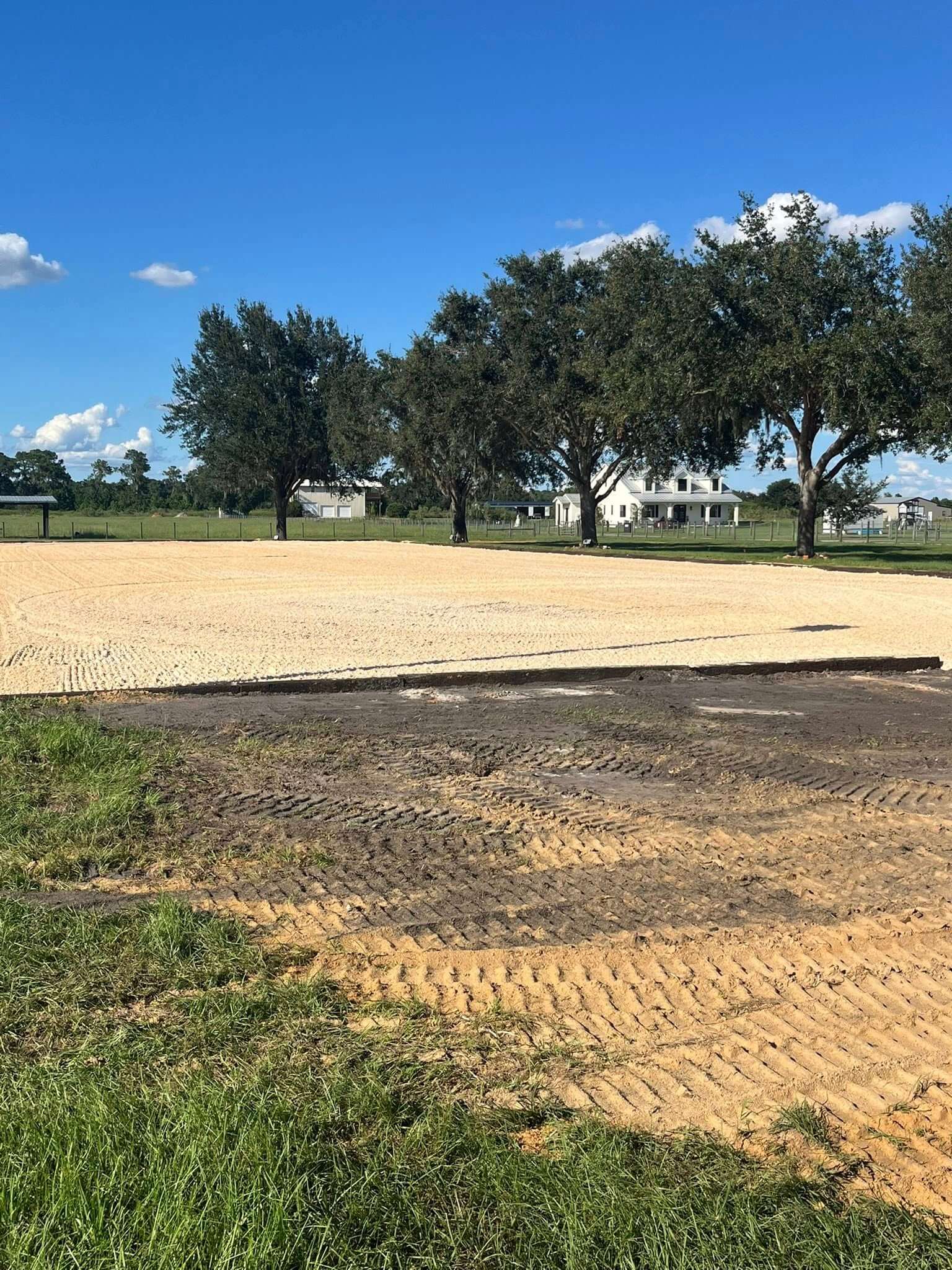 Completed horse arena with sand footing at a Florida farmhouse